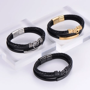 Close-up of multi-layer woven leather bracelets with anchor-shaped magnetic clasps