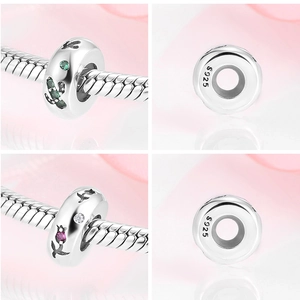 Macro detail of S925 silver spacer bead with flower engravings and zircon inlays