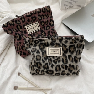Detail of leopard print plush cosmetic bags with Pleasant Time vintage woven labels