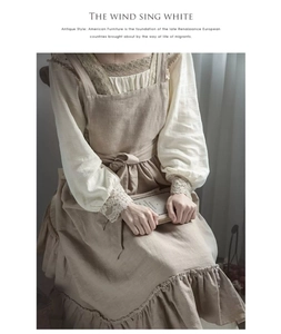 Detail of vintage cotton linen apron featuring ruffled hem and waist tie closure