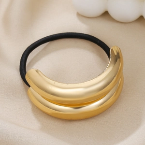 Detail of a black elastic hair tie with a double-layered polished gold metal U-shape charm
