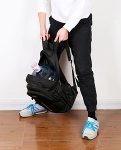 Spacious black Oxford backpack holding a large water jug to show heavy-duty capacity