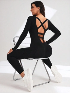 Detail of cross-back straps on a black seamless long-sleeve yoga bodysuit