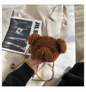 Detailed close-up of brown teddy plush bear crossbody bag on neutral background