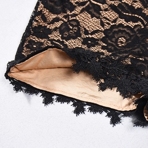 Detailed close-up of intricate black eyelash lace fabric with soft beige lining texture