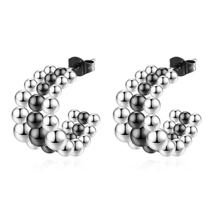 Polished silver and black beaded C-shaped stainless steel hoop earrings on white background