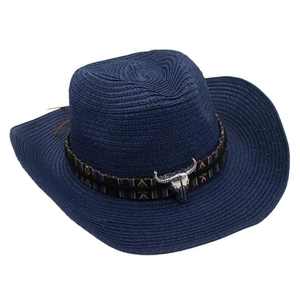Detail of dark blue straw cowboy hat featuring ethnic pattern band and metal bull head