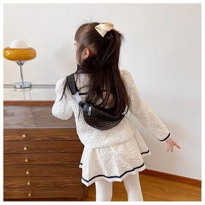Close-up of black quilted PU leather chest bag for kids with adjustable strap