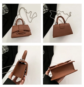 Macro views of brown mini handbag with litchi texture and silver bead chain strap