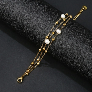 Three-layer 18k gold plated stainless steel bracelet with white pearls and small beads