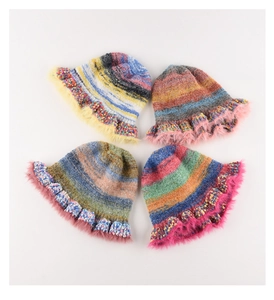 Close-up of rainbow gradient knit bucket hats with fluffy faux fur ruffled brim details
