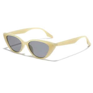 Retro cream cat-eye sunglasses with gray lenses shown from a 45-degree side angle