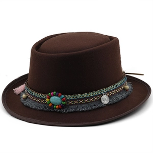 Detail of dark brown wool fedora with ethnic woven band and turquoise stone embellishment