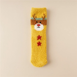 Detail of yellow coral fleece Christmas sock with reindeer motif and red stars décor