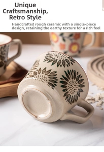 Close-up of handmade stoneware coffee mug showing sunflower pattern and crackle glaze texture