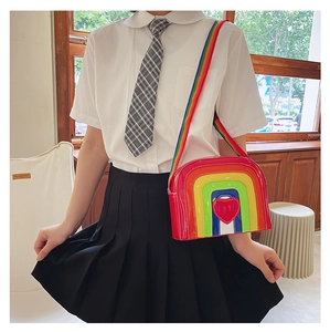 Close-up of rainbow striped crossbody bag with red heart patch on gloss finish