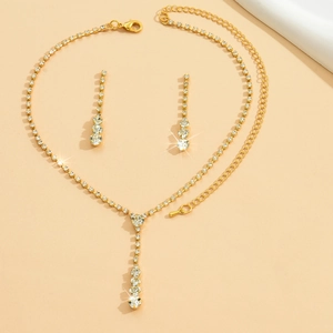 Macro shot of elegant gold bridal jewelry set with sparkling white rhinestones