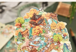 Macro shot of 3D Chinese garden sticker with pavilions, cranes, and autumn scenery details