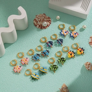 Variety of colorful enamel koi fish hoop earrings displayed with sea shells and pearls