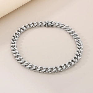 Macro shot of a 13mm silver Cuban link bracelet with a secure box clasp closure