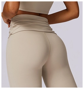 Detail showing the ruched high-waist and booty lifting seams on beige yoga leggings