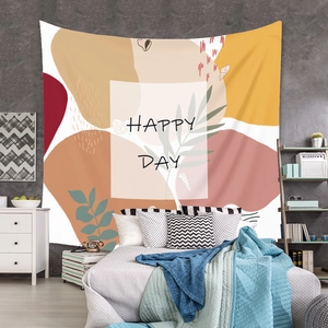 Detail of bohemian tapestry featuring abstract plants, geometric shapes and Happy Day text