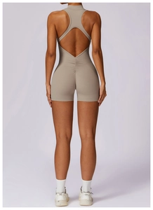 Back view of high-stretch beige yoga bodysuit with racerback and ruched detail