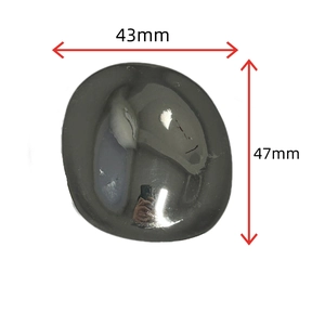 Macro shot of polished oval dark grey obsidian stone showing 43mm by 47mm dimensions