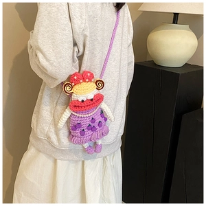 Detail of colorful handmade crochet doll crossbody bags with pearls and sausage lips