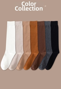 Vertical pile of seven classic color calf socks with comfortable ribbed cuffs