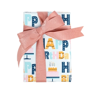 Cartoon Happy Birthday gift wrapping paper with colorful prints and pink satin ribbon bow