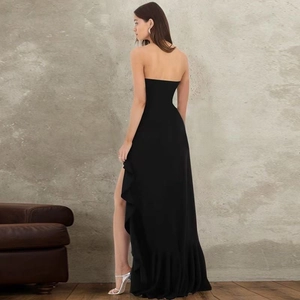 Detail of elegant black strapless dress with ruffle trim and high side slit design