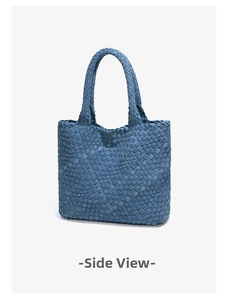 Detailed side view of denim blue woven tote bag with intricate texture and double handles