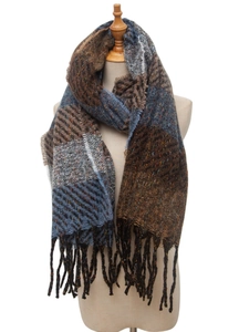 Detail shot of brown and blue striped scarf with fringe trim on a mannequin