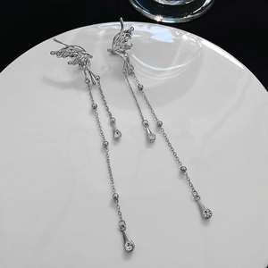 Detail view of silver butterfly tassel earrings with sparkling crystal accents