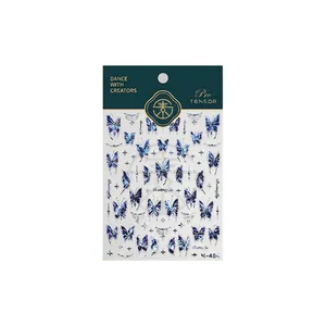 Iridescent blue butterfly nail stickers with gold accents and stars for nail art design