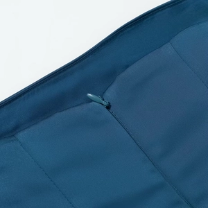 Macro shot of invisible zipper and satin texture on a navy blue strapless dress