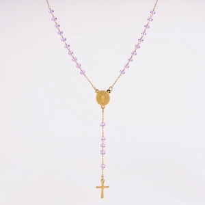 Close-up of golden rosary necklace featuring light purple faceted crystal beads and cross