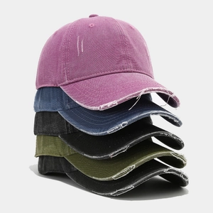 Close-up of distressed vintage baseball caps in multiple colors with frayed edge details