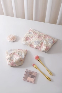 Detail of floral embossed fabric makeup bags with premium zipper and storage capacity