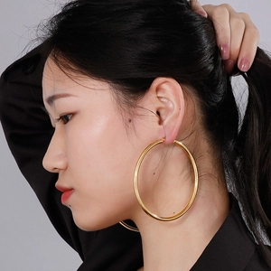 Classic large golden hoop earrings for women, featuring a smooth polished metal finish