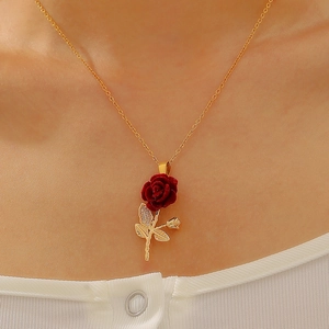 Gothic rose heart necklace with red velvet flower and gold chain worn on neck