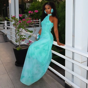 Close-up of light blue tie-dye halter neck maxi dress with elegant cloud earrings