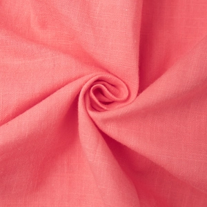 Close-up of soft coral pink cotton fabric texture with detailed woven fiber pattern