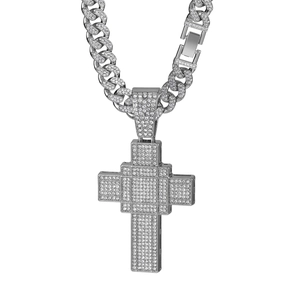 Macro shot of silver hip-hop Cuban chain and cross pendant with clear cubic zirconia