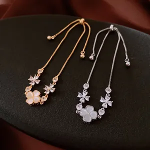 Adjustable gold and silver flower bracelets with cat-eye stone pendants and diamond accents