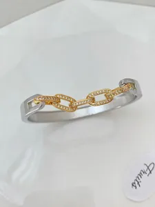 Two-tone geometric C-shaped open bracelet with gold chain link and pavé zircon inlay