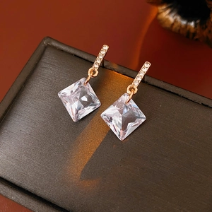 Detailed close-up of sparkling rhodium-plated earrings with large rhombic zircon drops