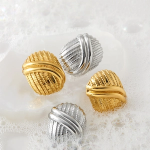 Vintage oval button stud earrings in gold and silver with striped texture and smooth arcs