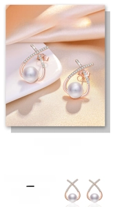 Detail of rose gold pearl earrings with zircon crisscross design on pink silk background